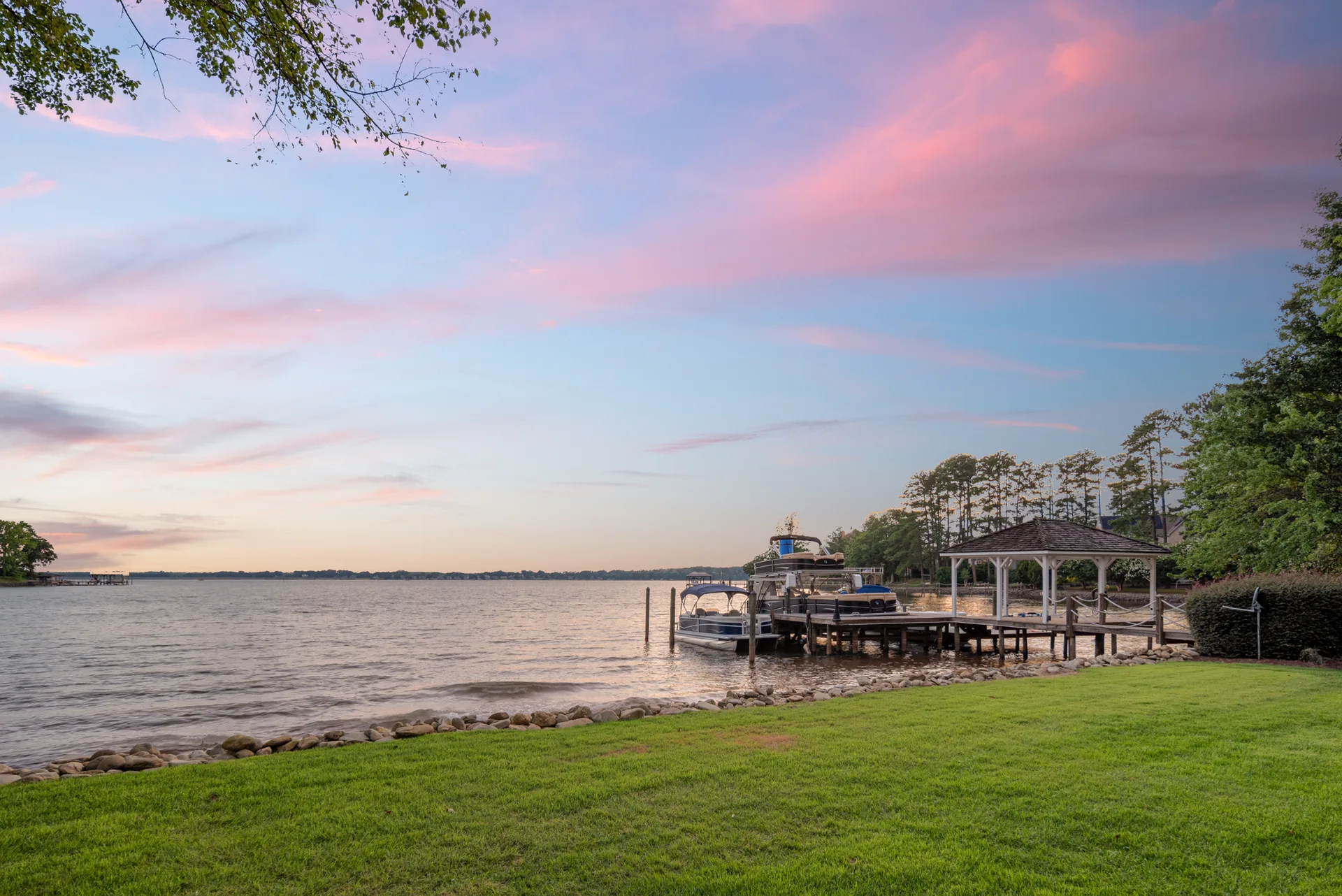 Lakefront backyard with sunset over the water