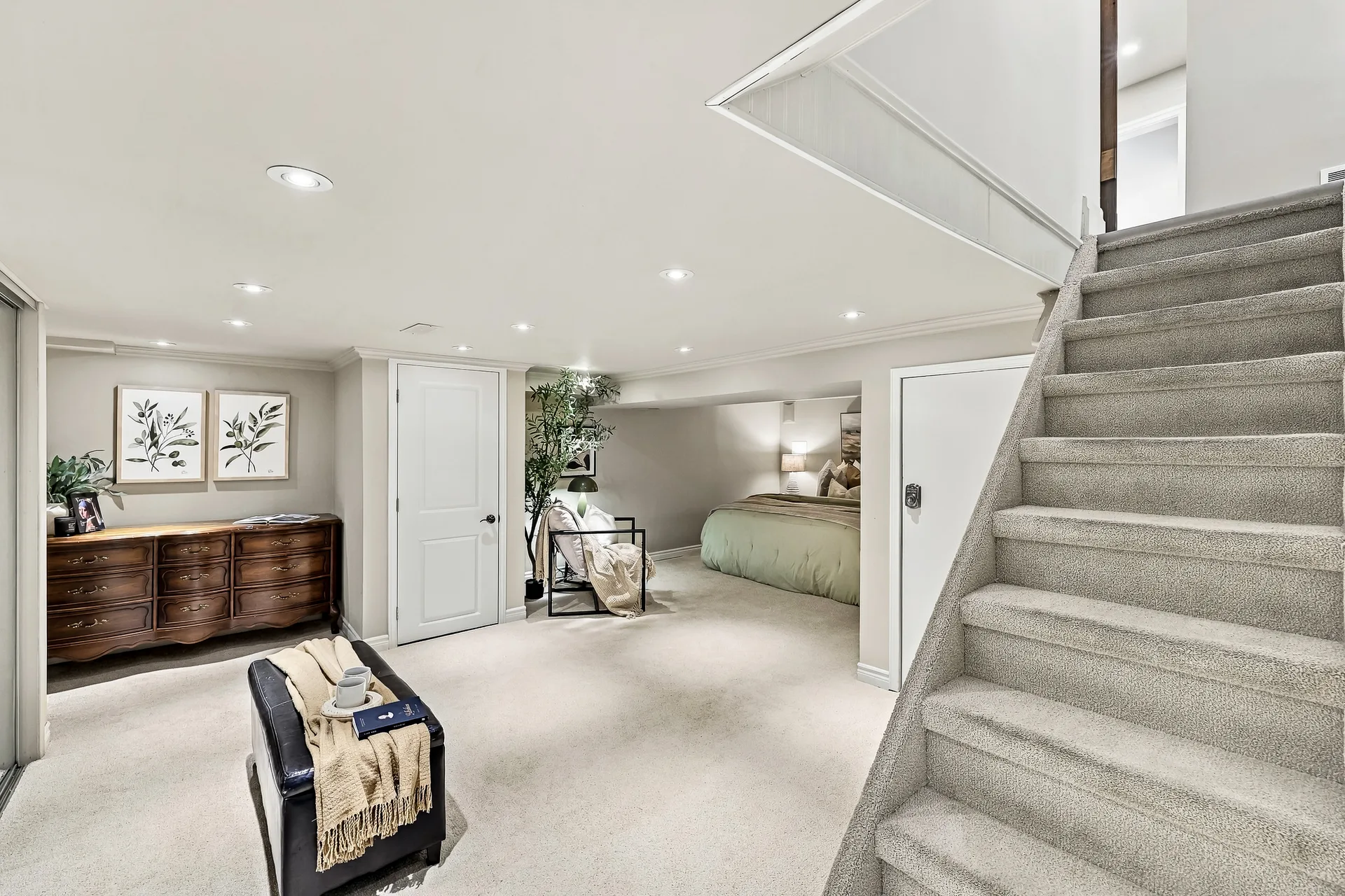 Lower-level bedroom suite with carpet and recessed lighting