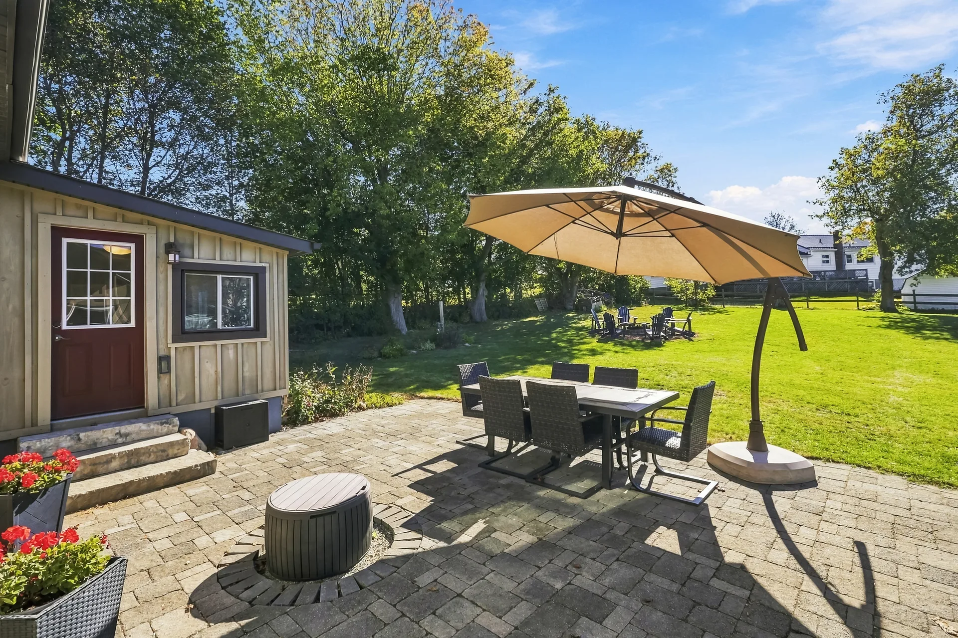 Stone paver patio with dining set and planter boxes