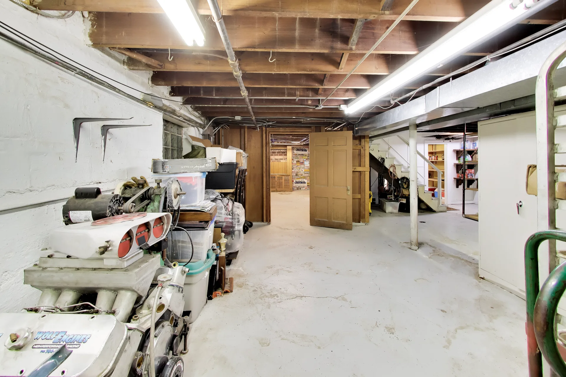 Unfinished basement space with tall shelving