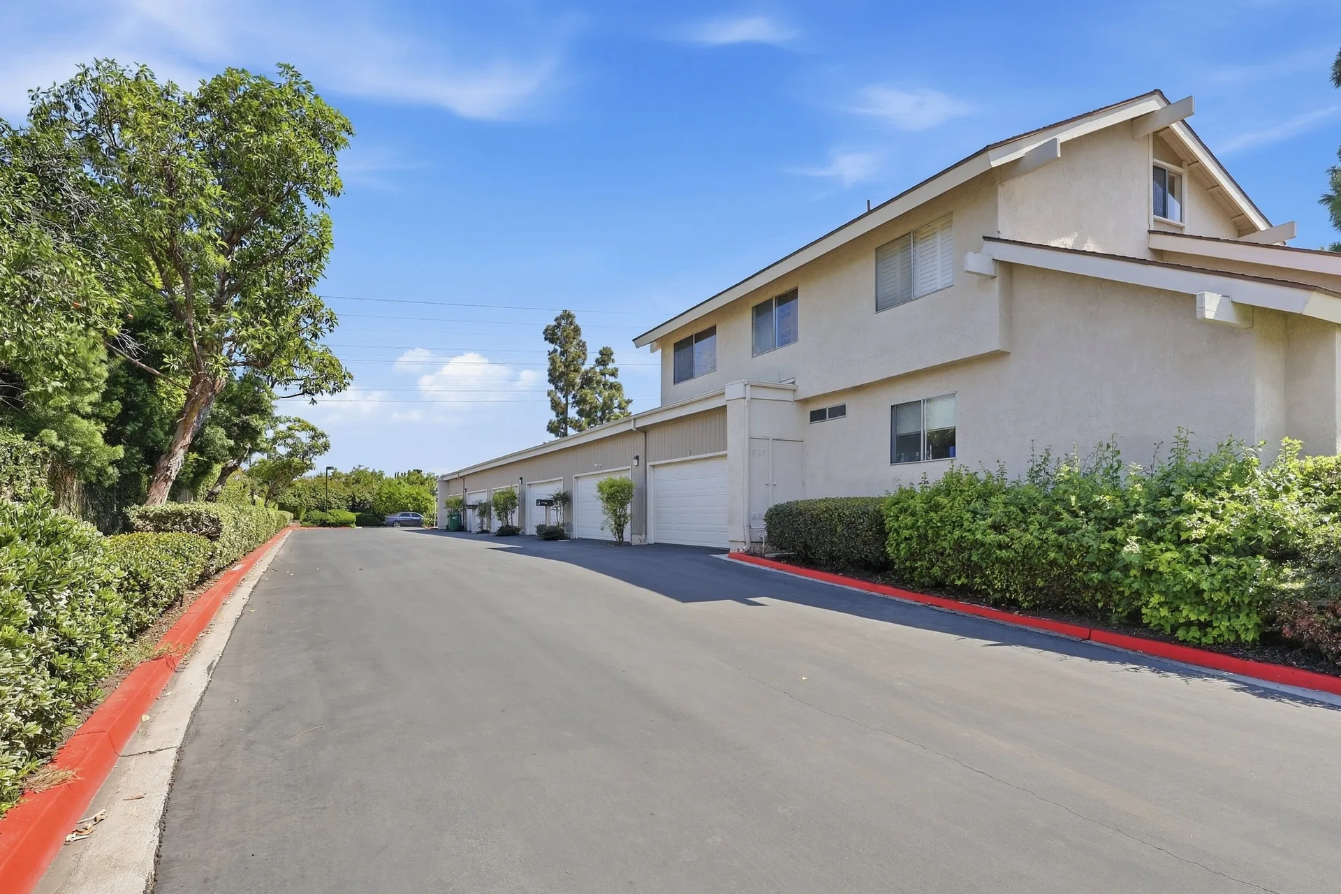 Side profile of 8 Silverwood showing the row of attached garages and driveway