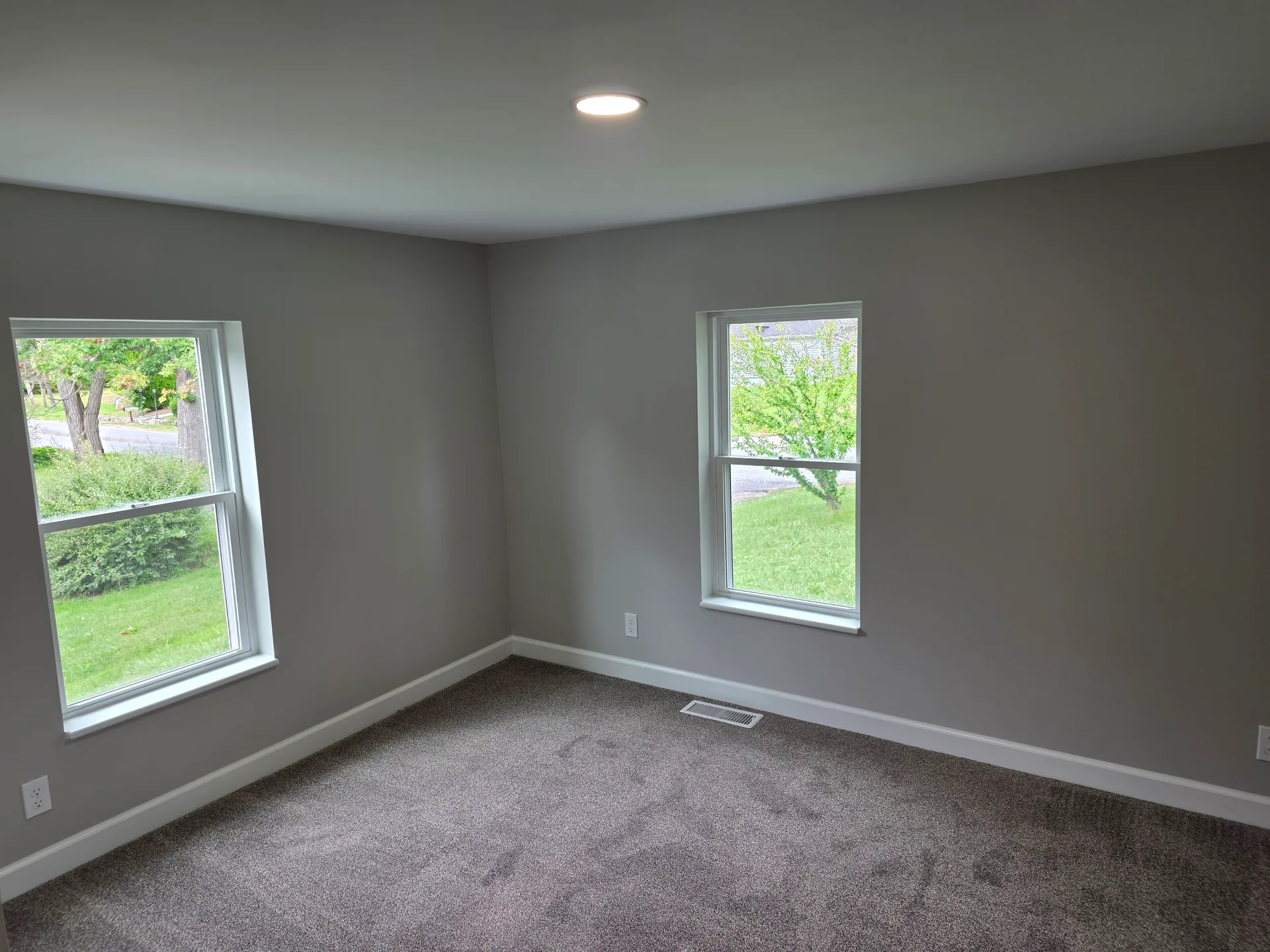 Bedroom with grey walls and carpeted flooring