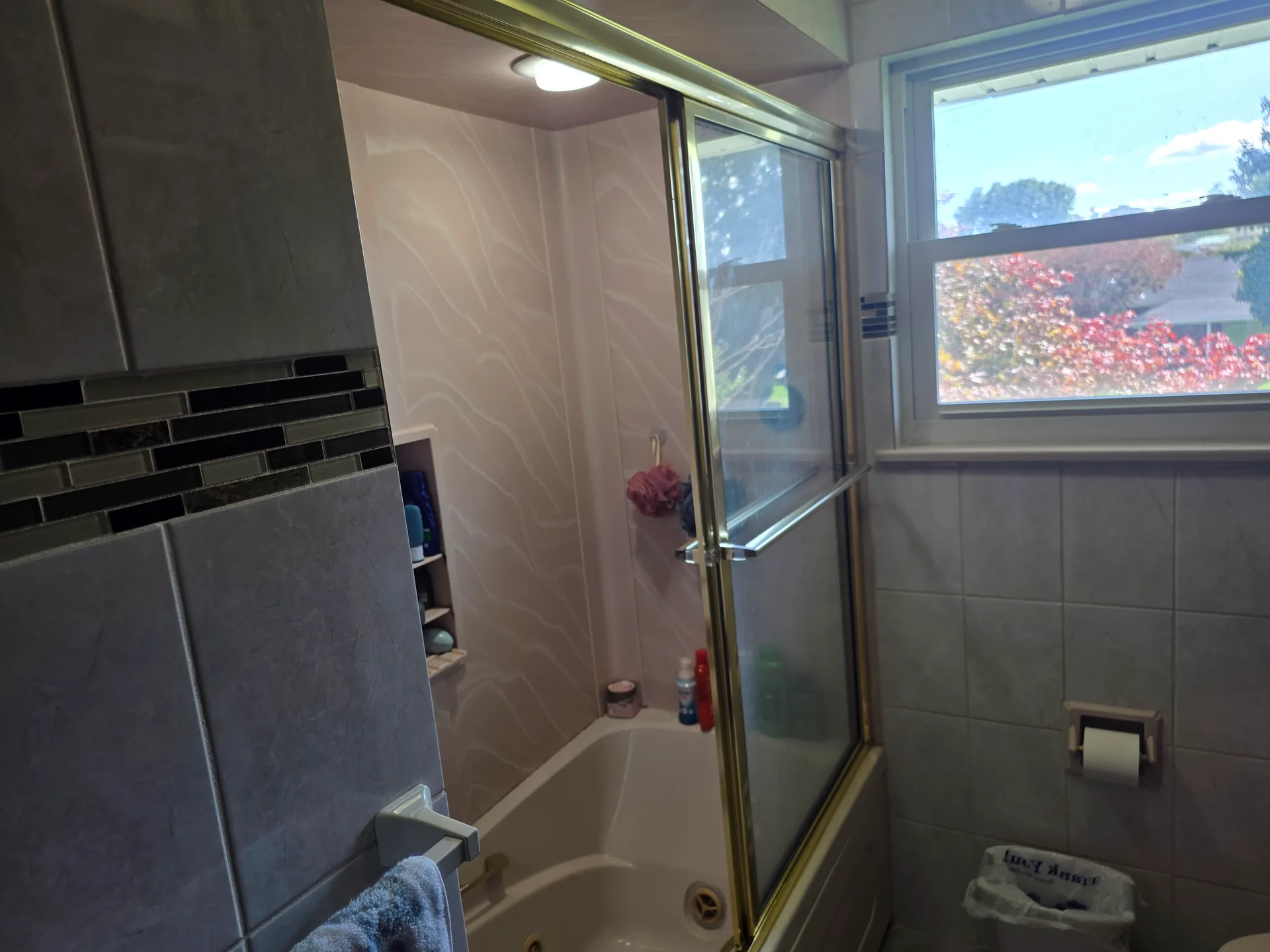 Bathroom with tiled tub and shower