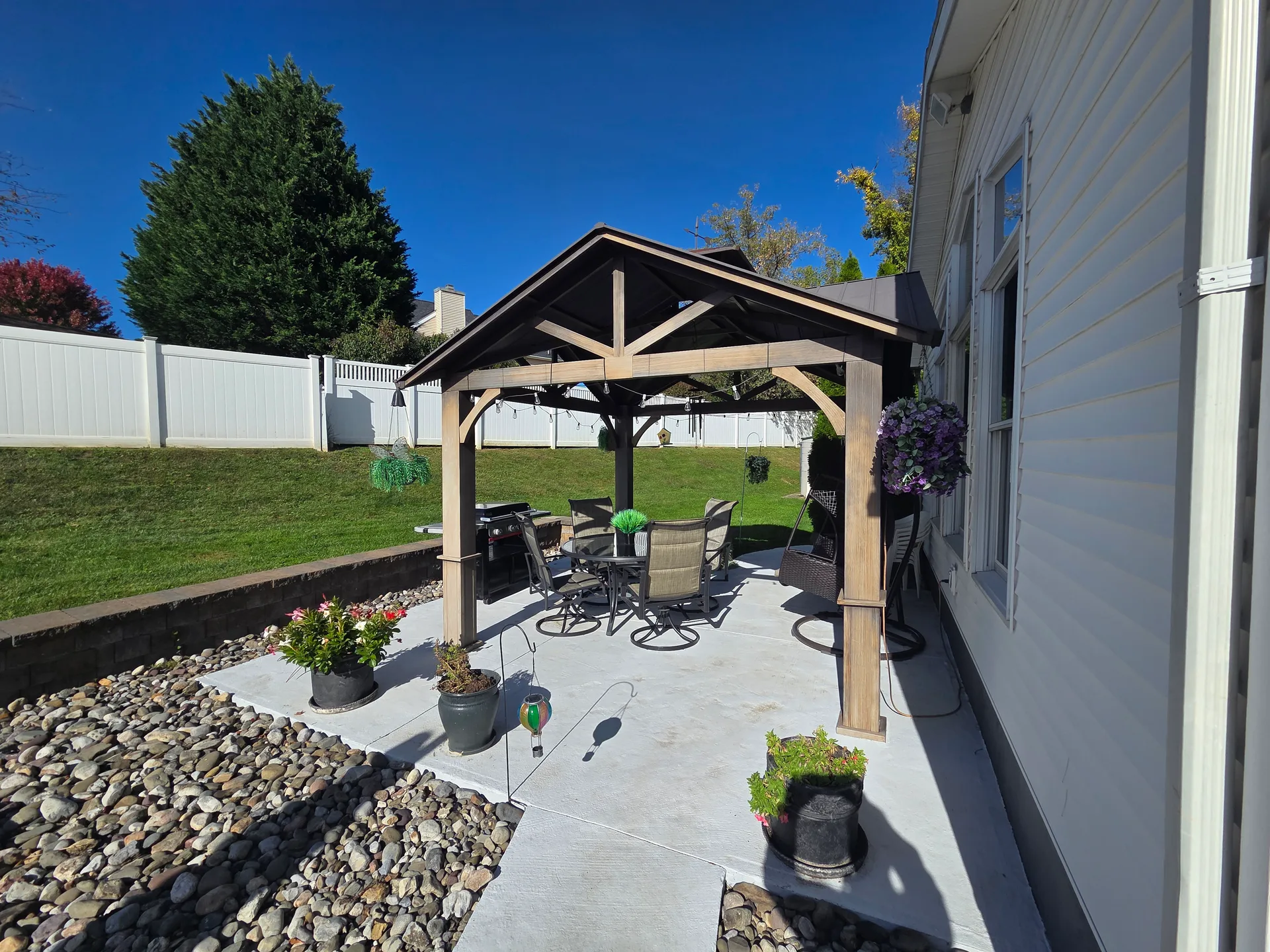 Backyard patio and gazebo surrounded by mature landscaping at 1906 Grouse Court, Forks Township PA