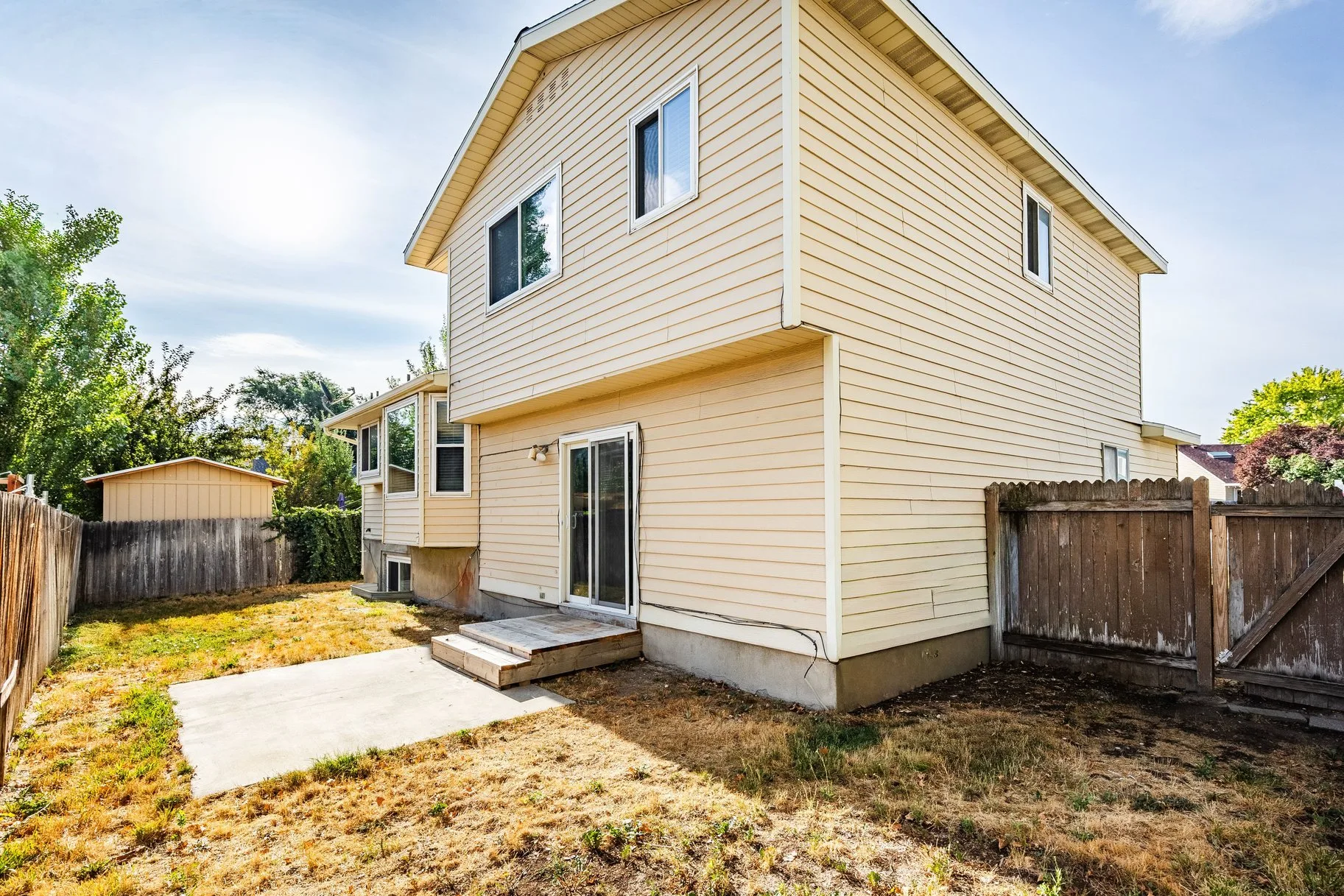 Rear of home showing patio and privacy fence