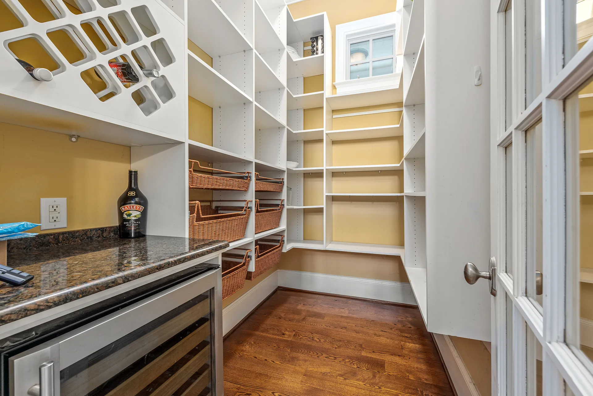 Walk-in pantry with custom white shelving