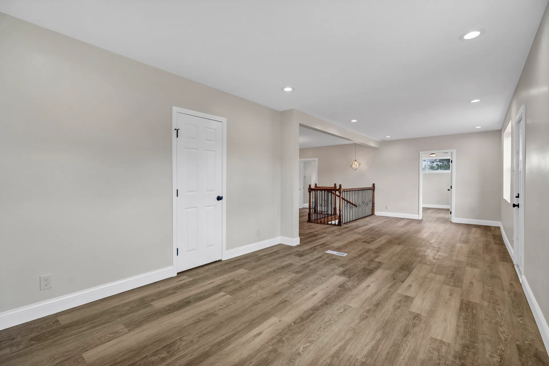 Living area with staircase and white paneled doors