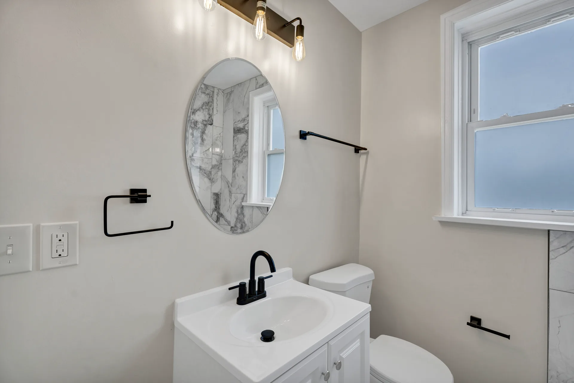 Modern renovated bathroom with marble-look tile