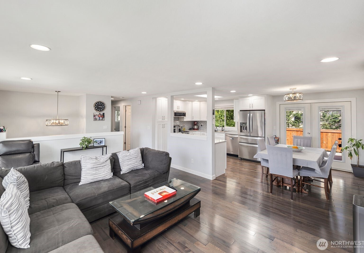 Open-concept living area with morning light through patio doors