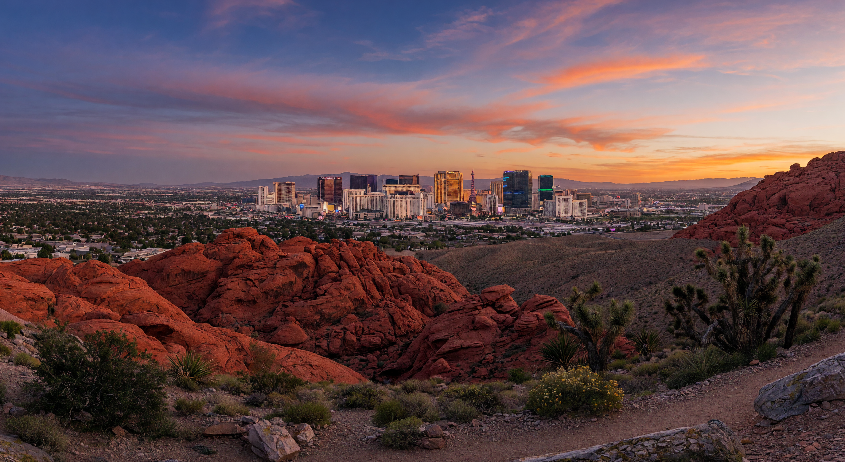 Panoramic view of the Las Vegas skyline with Red Rock Canyon at golden hour