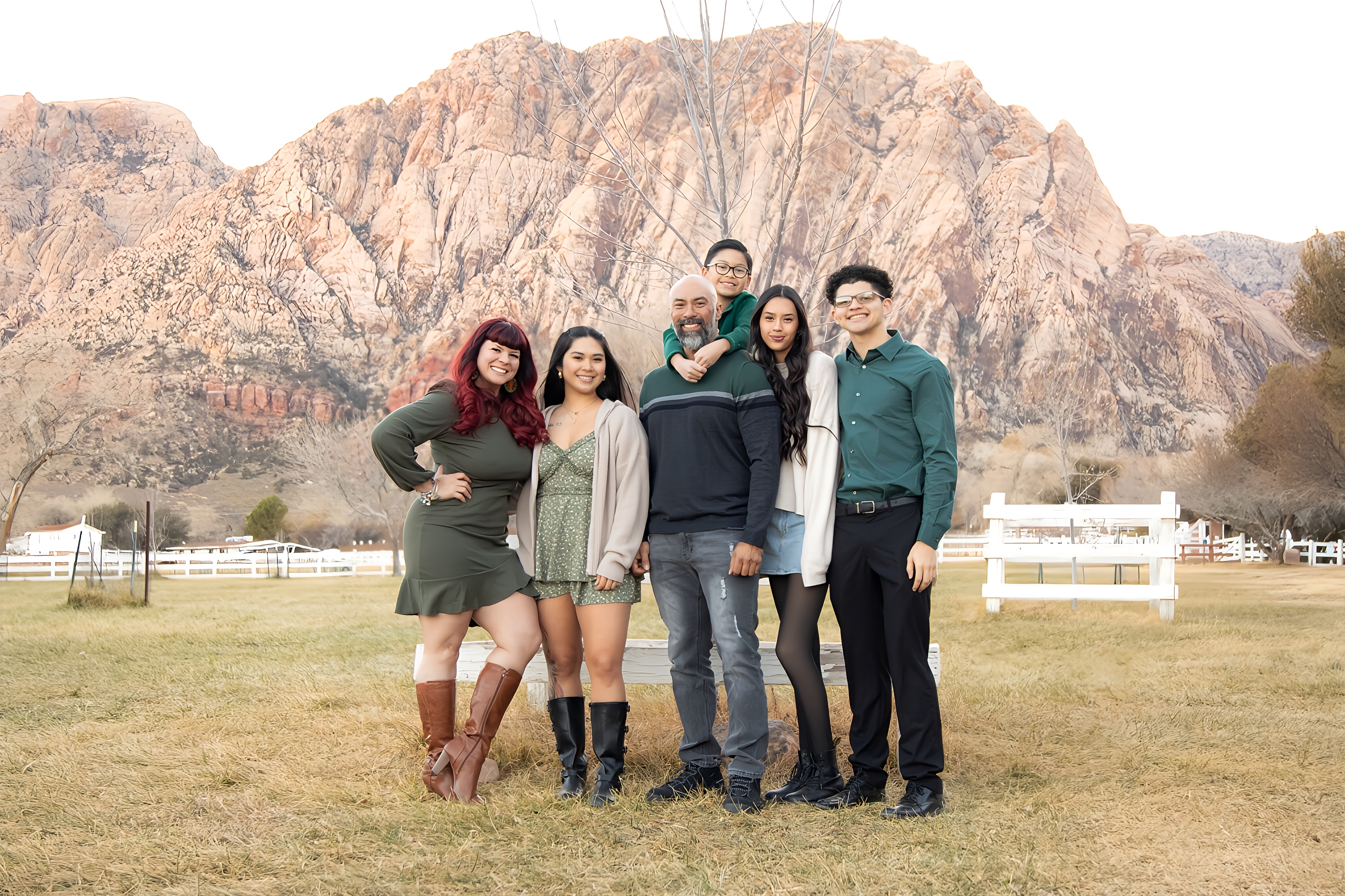 Samantha Medeiros with her family in front of scenic desert mountains