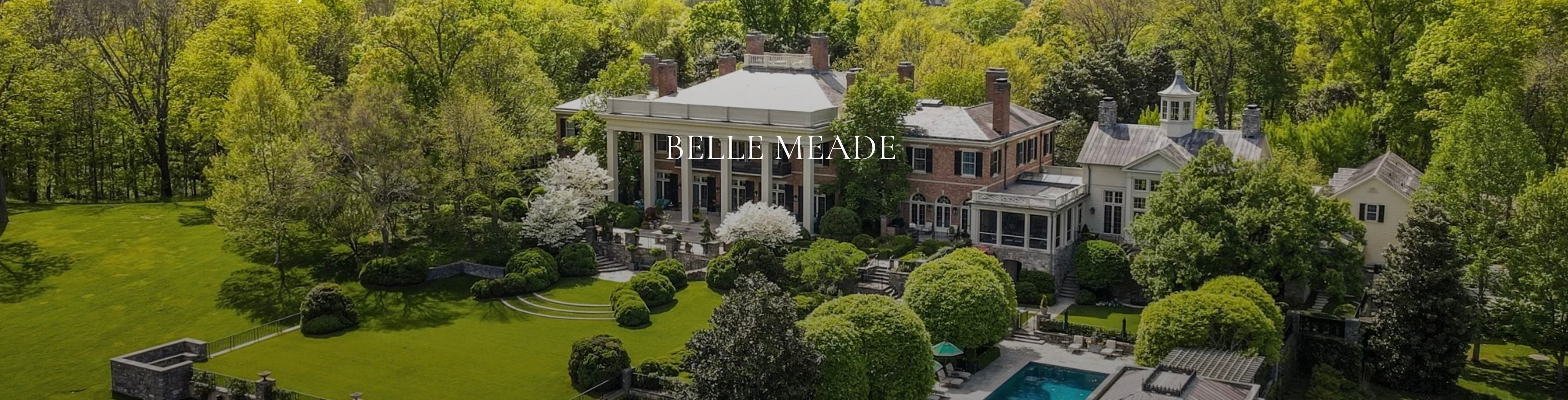 Aerial photograph of an expansive luxury estate labeled Belle Meade surrounded by lush greenery