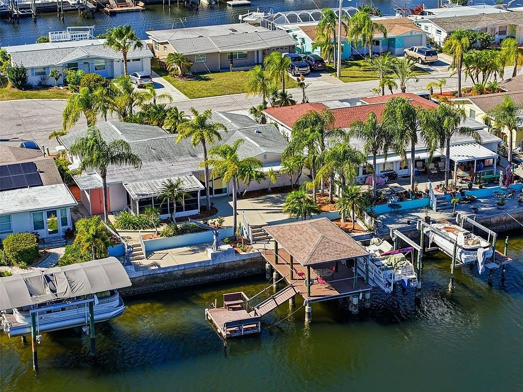 Elevated aerial shot of the waterfront home, dock, and canal