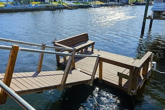 Floating dock with wooden gangway extending over the canal