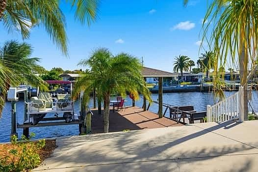 Canal view with private dock, covered pavilion, and boat lift
