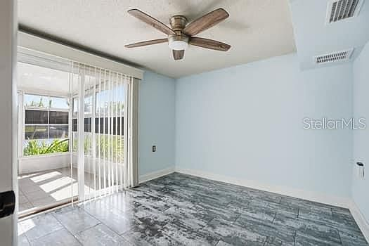 Third bedroom with sliding glass door opening to the screened porch