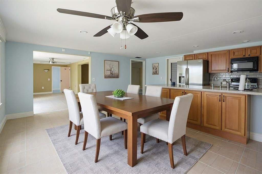 Dining area adjacent to the kitchen with wood table and six chairs
