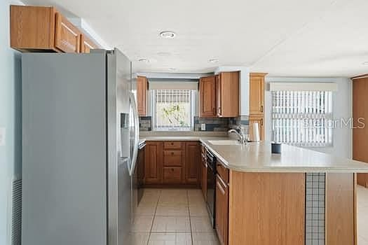 Kitchen gallery view with oak cabinets and tile flooring