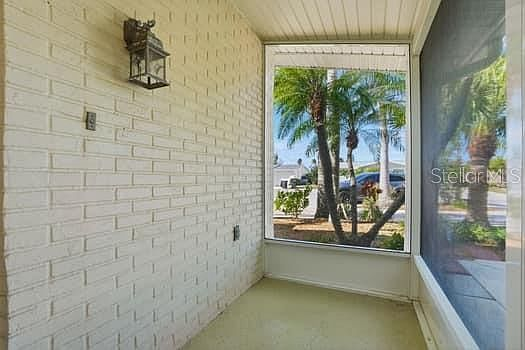Screened-in front porch entry with white brick walls