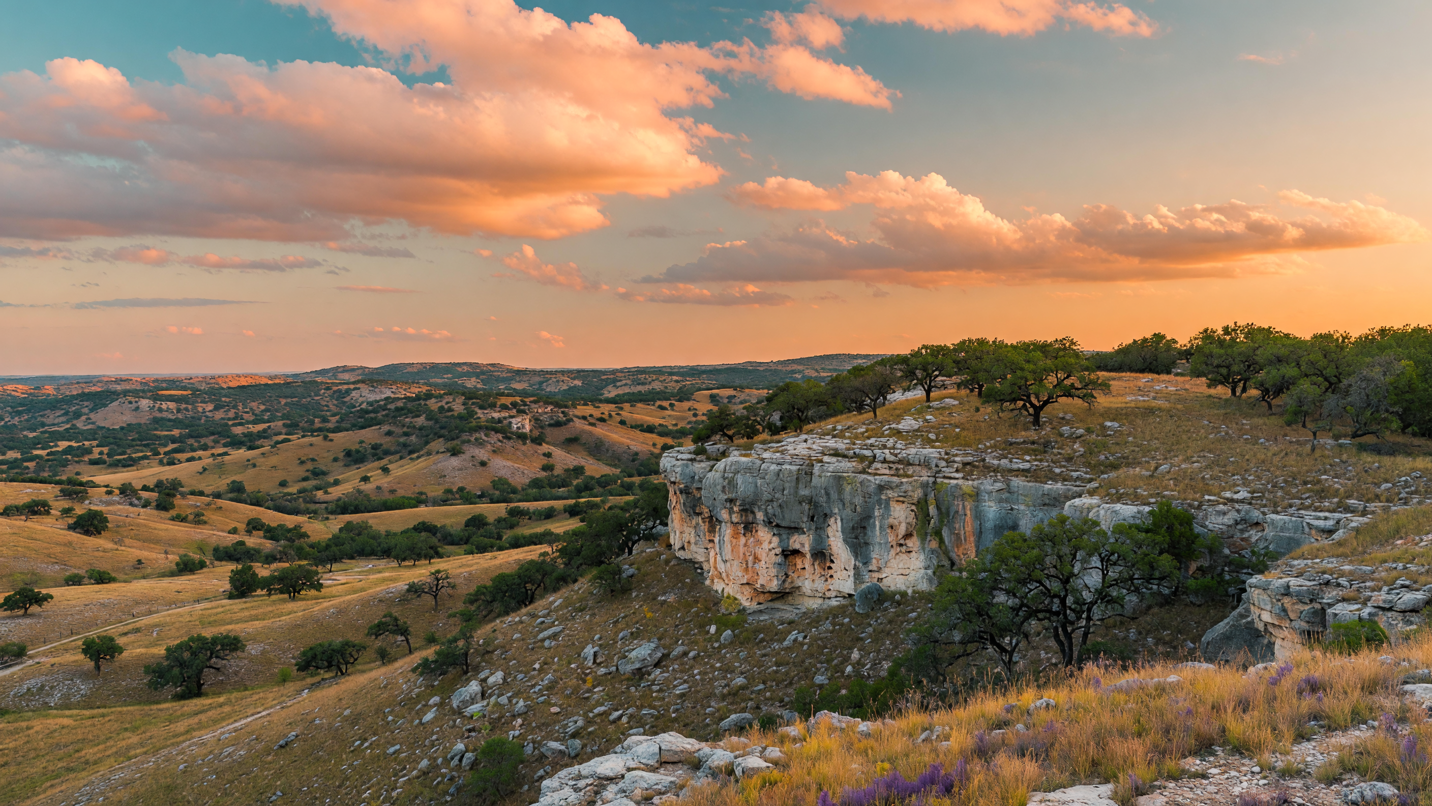 Rolling limestone hills and live oaks of the Texas Hill Country near Boerne, where Cascade Caverns is located