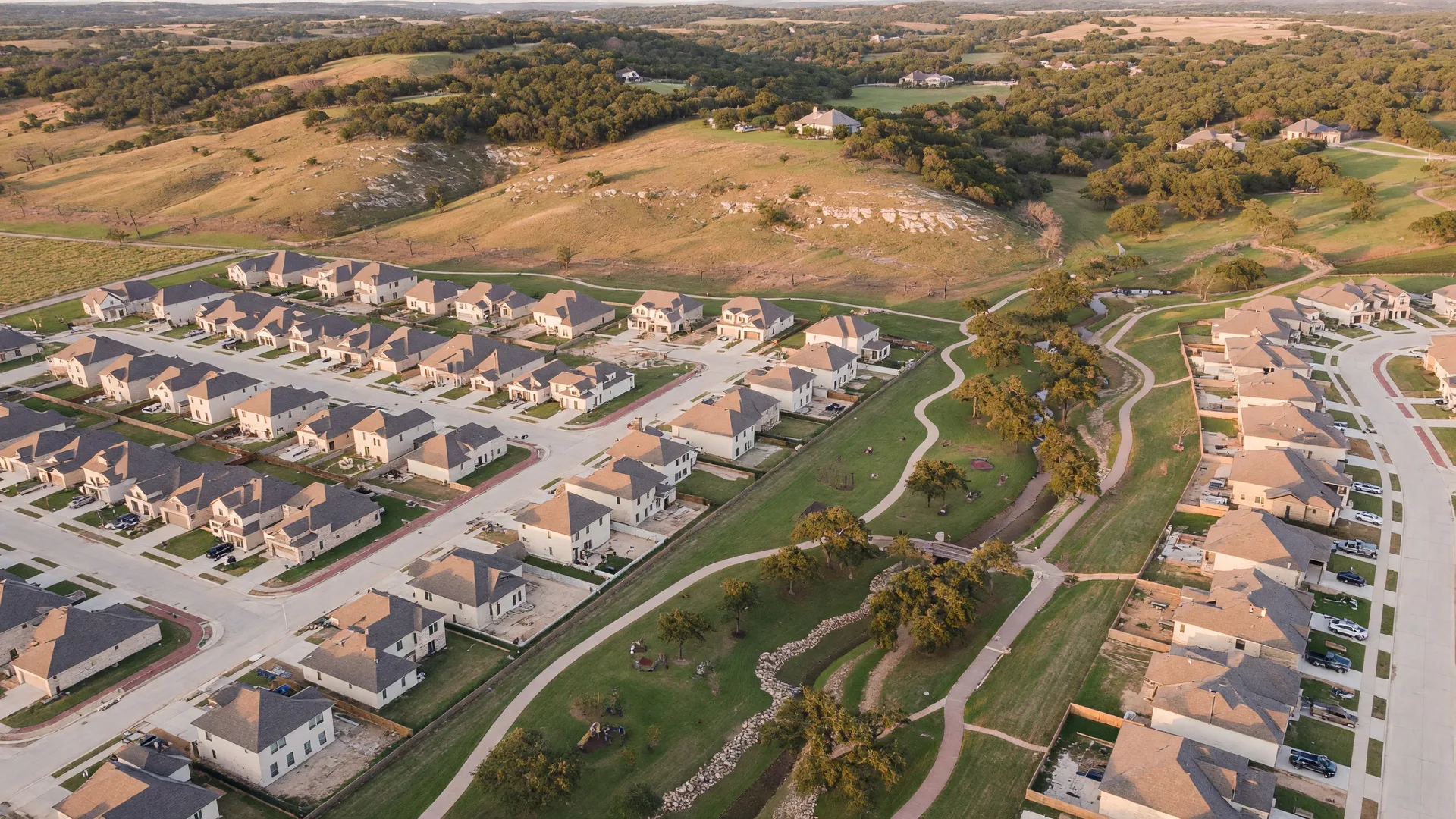 Aerial view of Miralomas master-planned community in Boerne Texas with Hill Country terrain, live oaks, and homes on elevated ridgeline lots