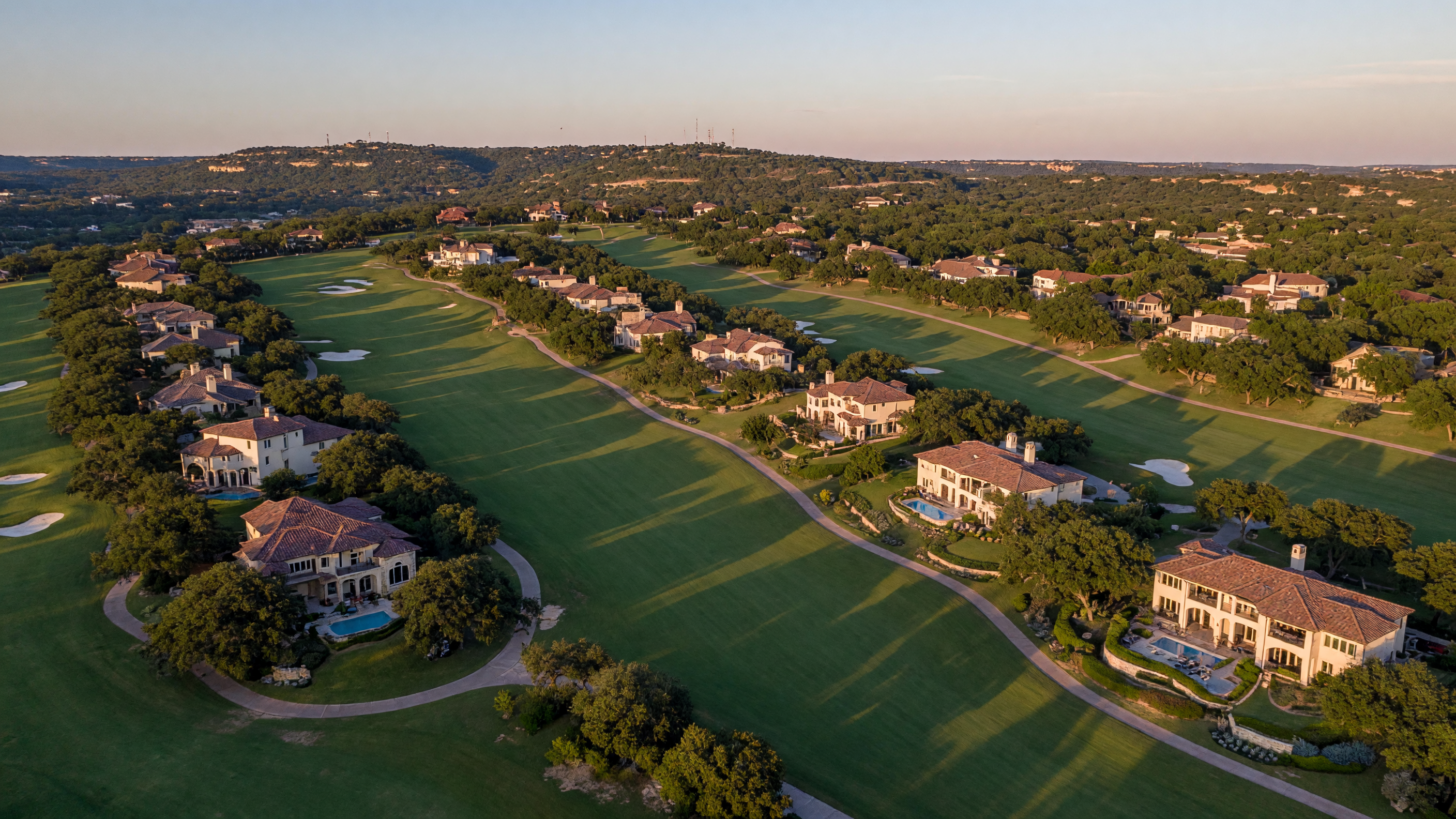 Upscale estate homes in The Dominion featuring Mediterranean and Hill Country architectural styles with mature landscaping