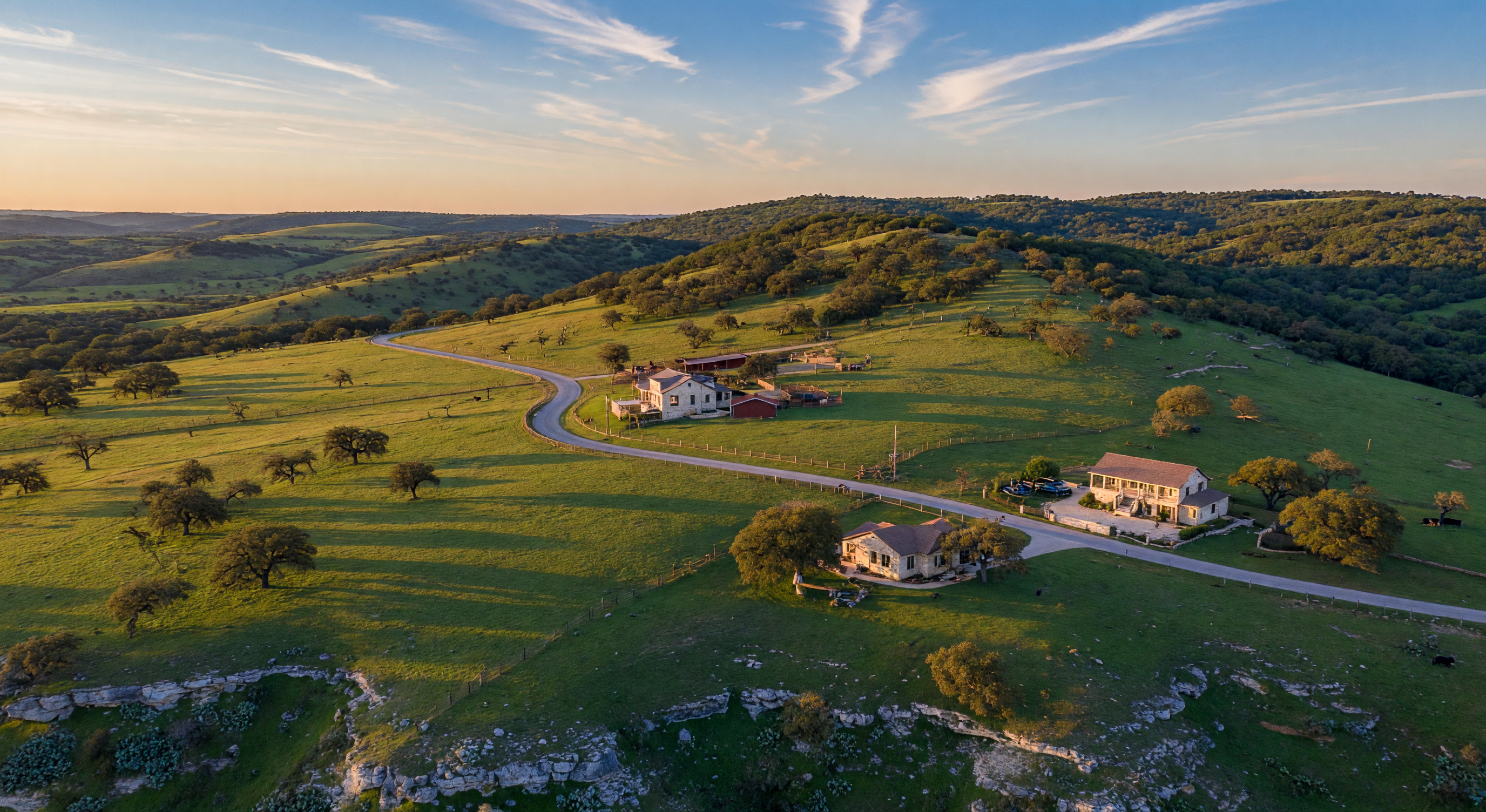 Texas Hill Country landscape with rolling green hills and live oaks at golden hour