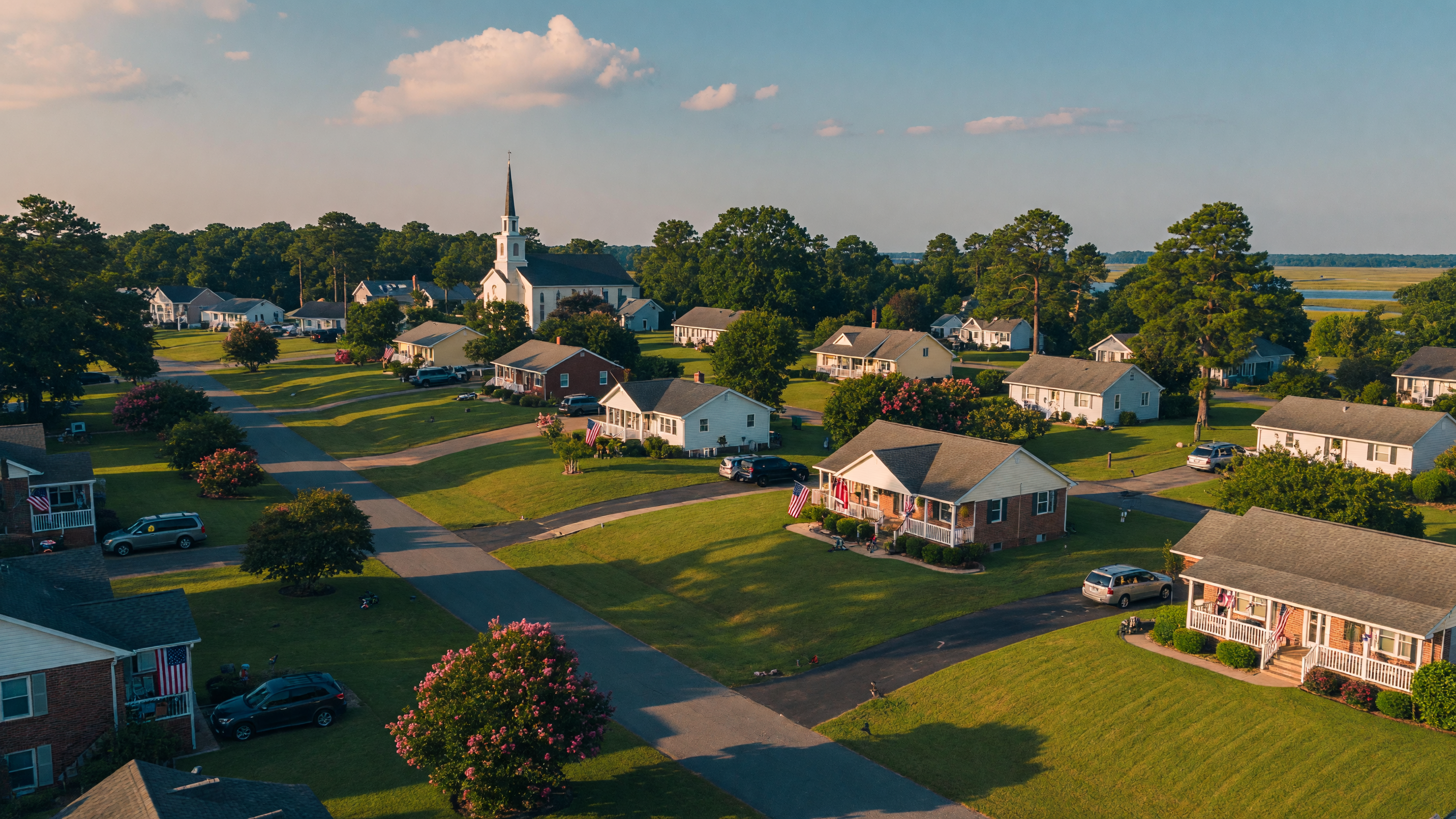 A welcoming tree-lined Virginia neighborhood with American flags on porches, representing military-friendly communities near Virginia bases