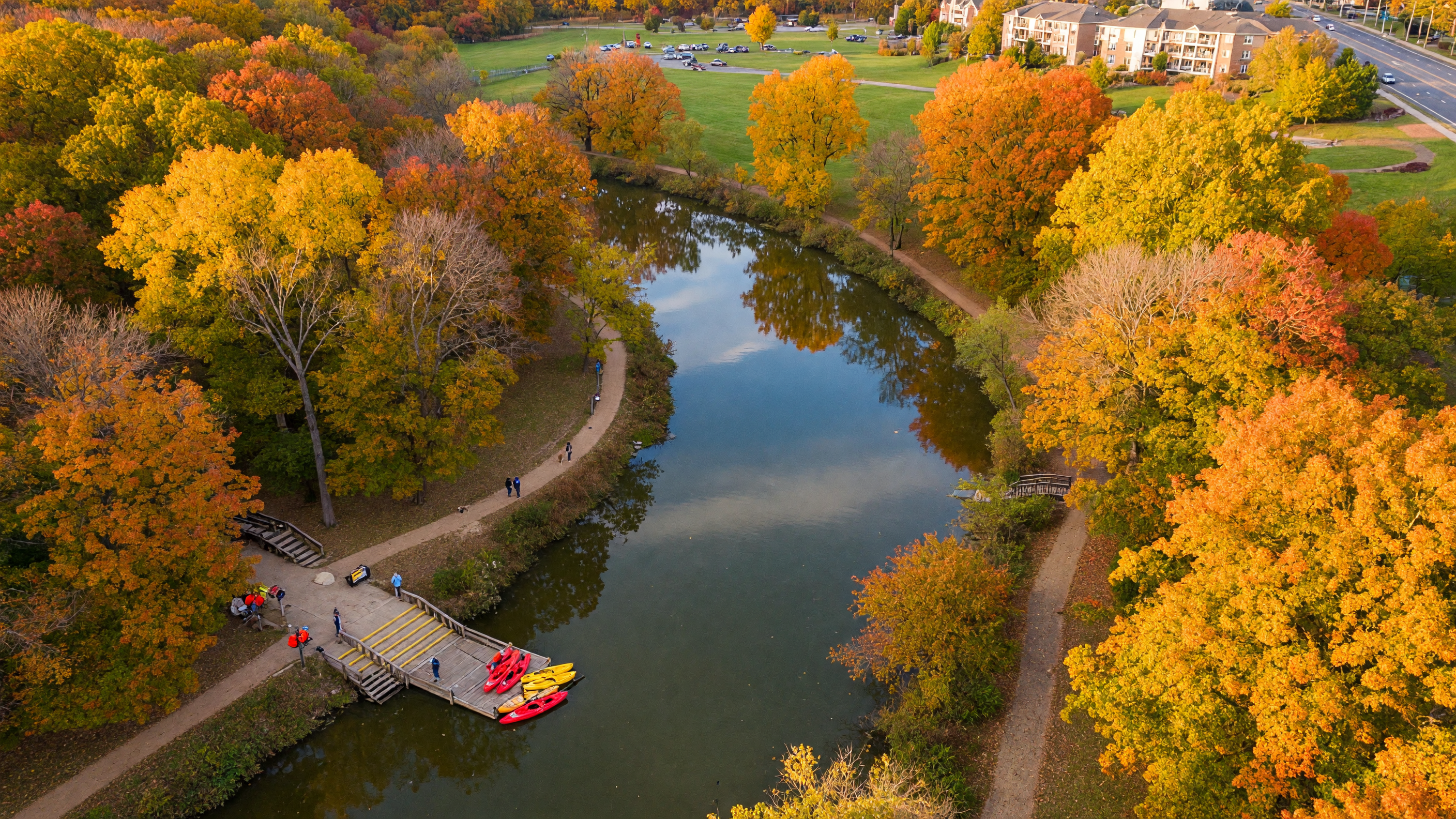 Overpeck County Park's kayak launch along Overpeck Creek in Leonia, surrounded by mature autumn trees and calm reflective water