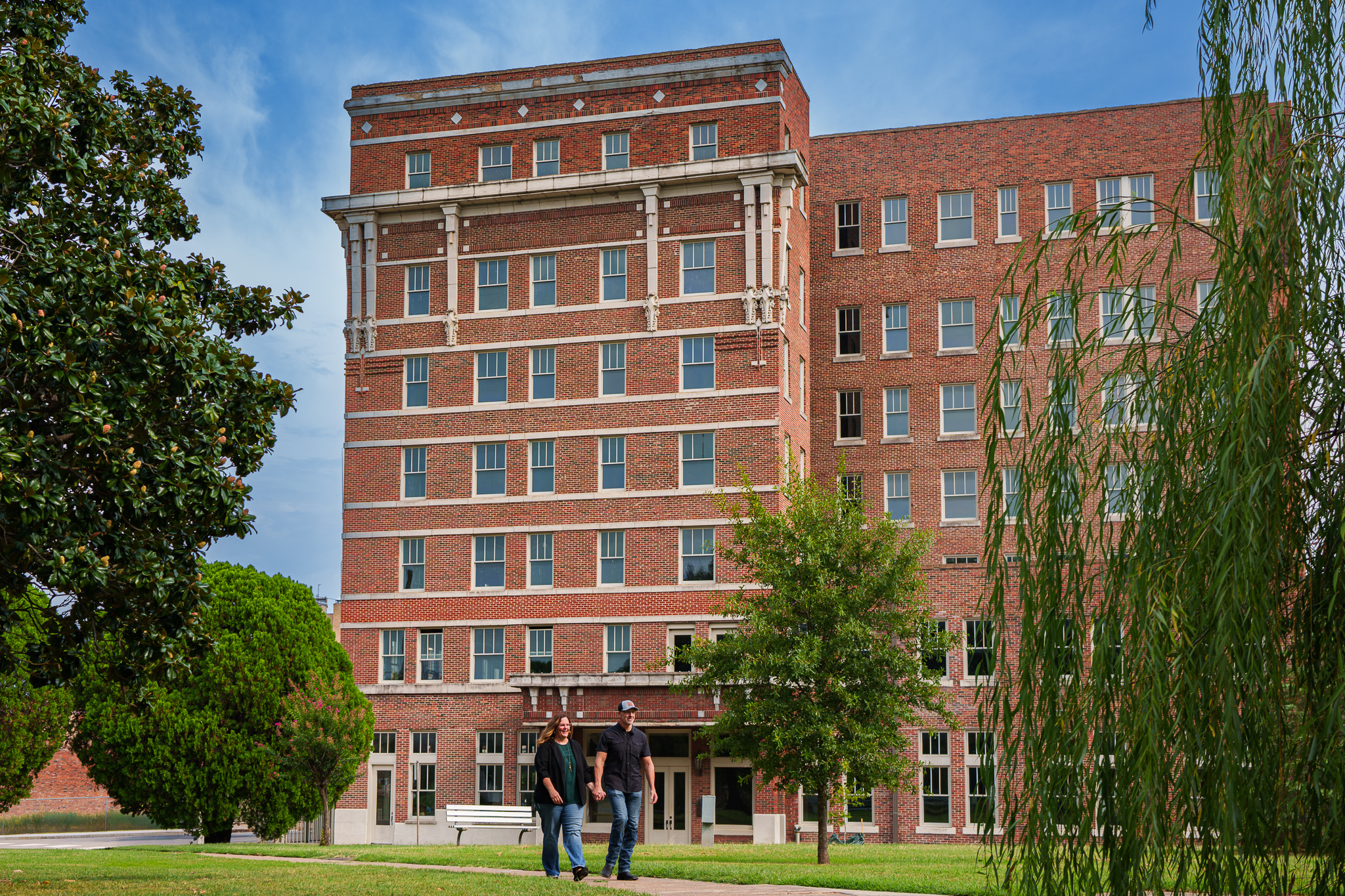 Shannon and Scott Miles walking in front of a historic brick building