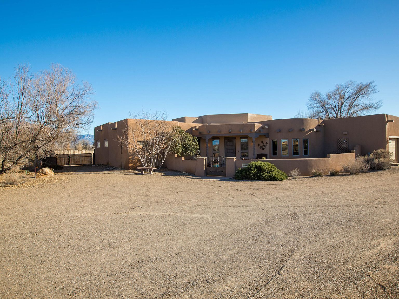 Wide view of the front courtyard with Pueblo Revival architecture