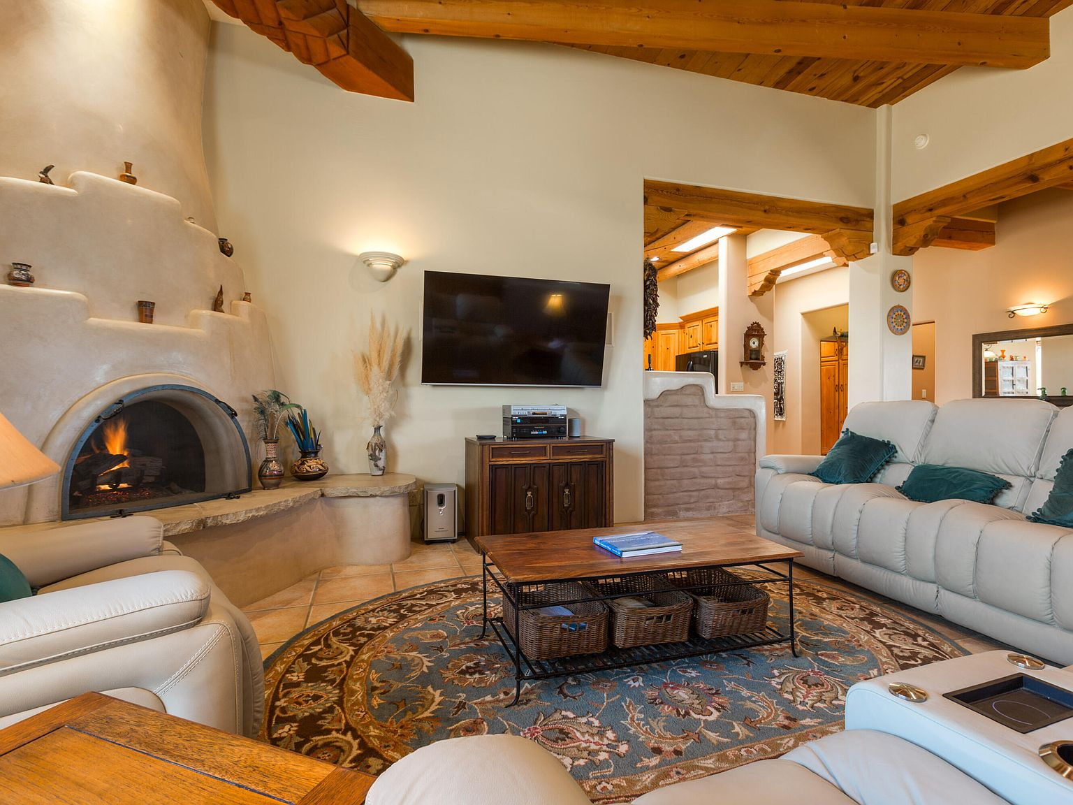 Living room featuring a custom plaster kiva fireplace