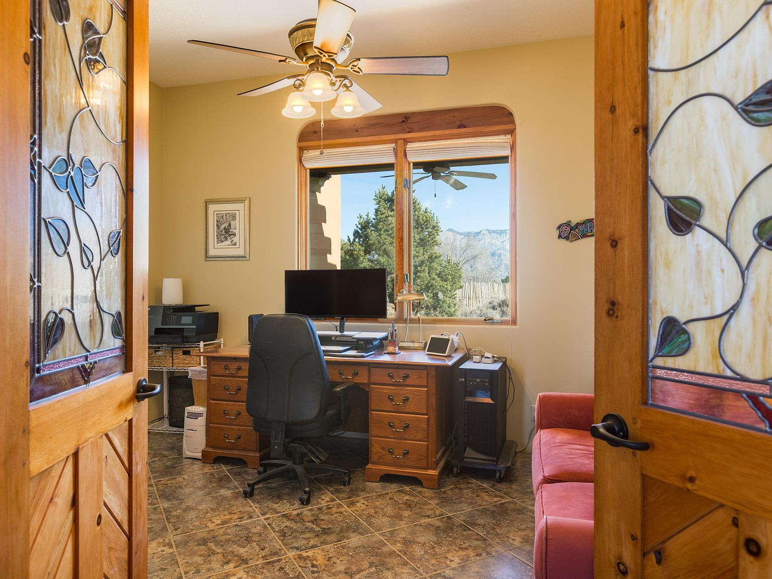 Home office with stained glass double doors and mountain views