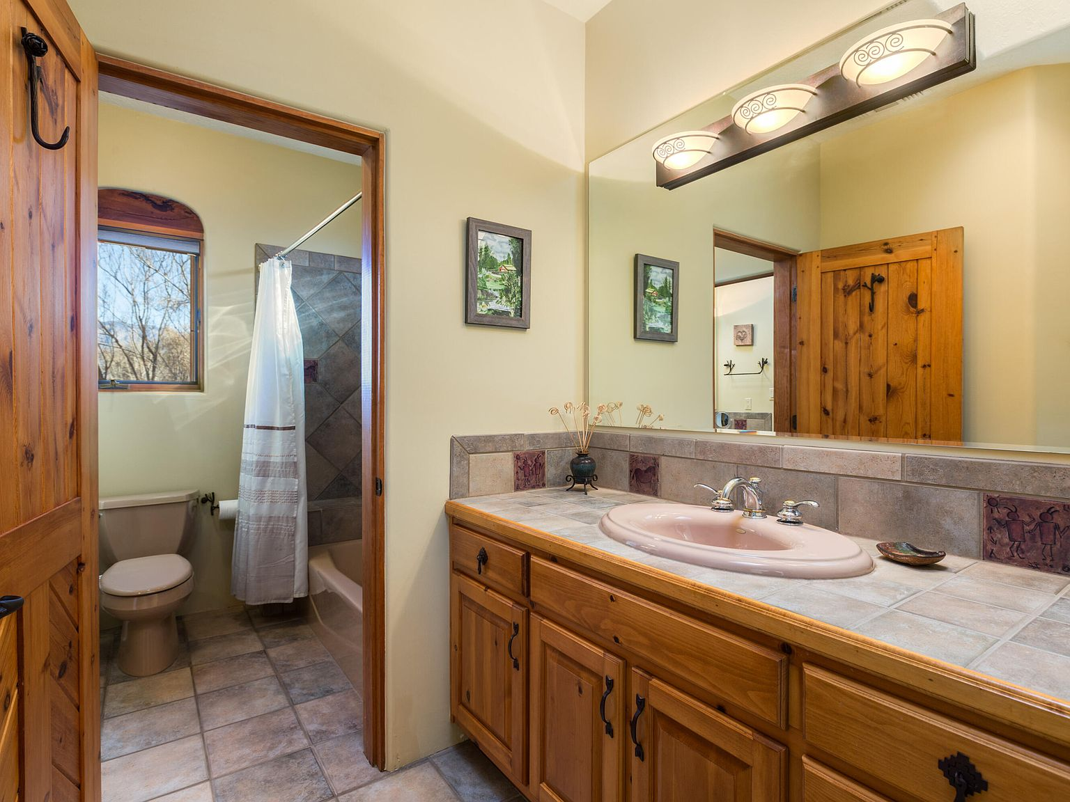 Bathroom vanity with pine cabinets and tile countertops