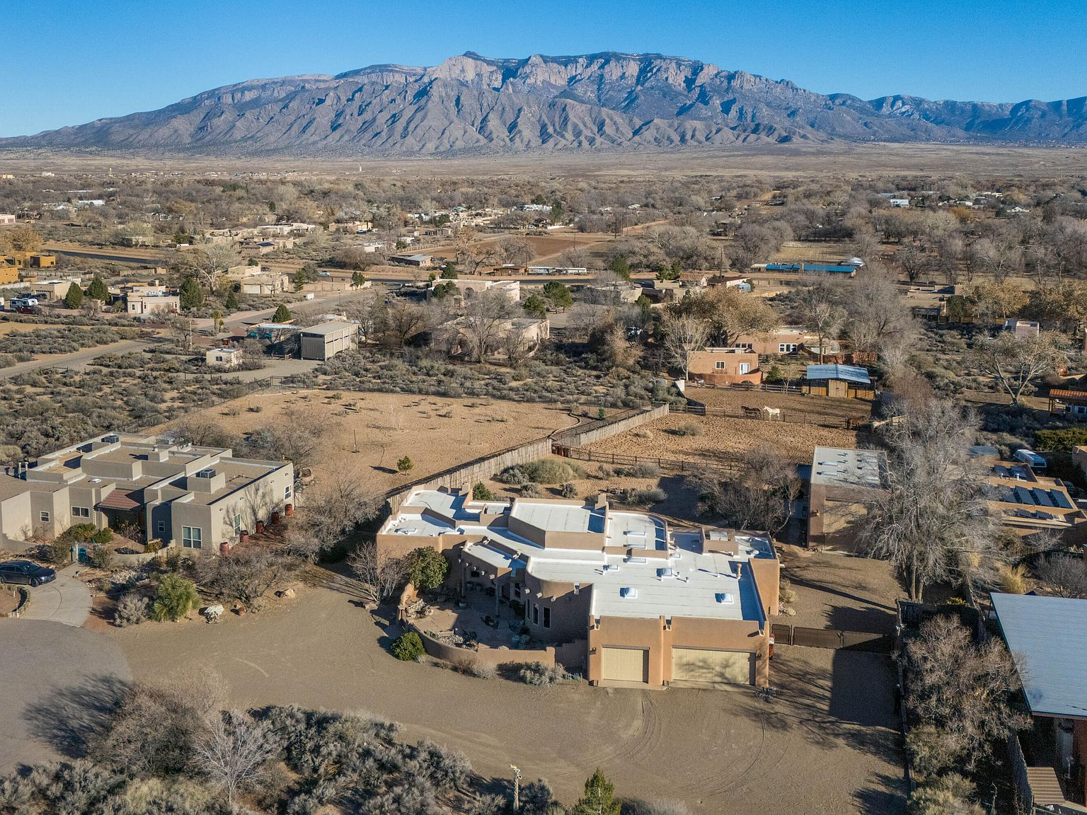 Aerial drone view of the property with Sandia Mountains in the background