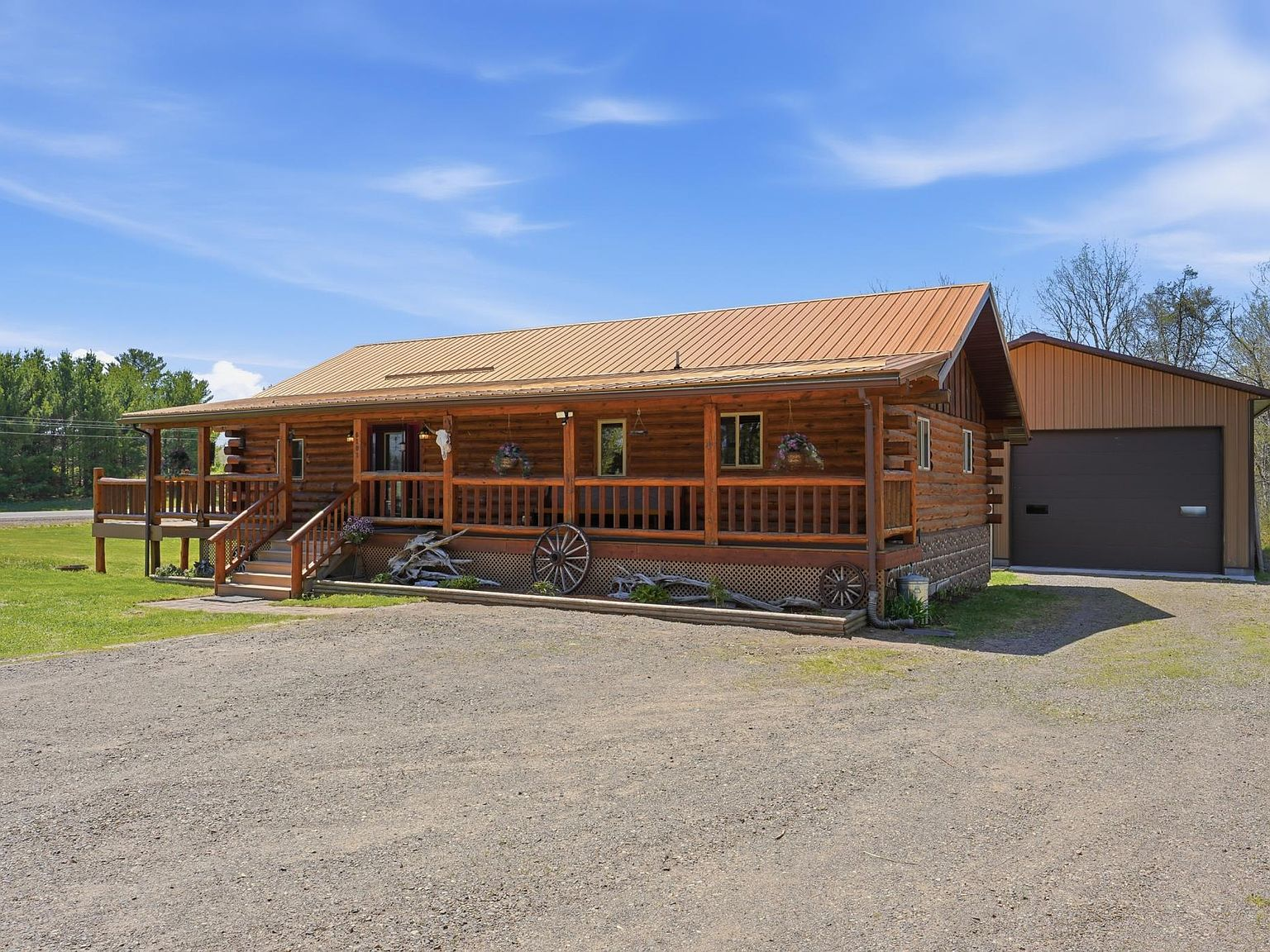 Front facade with detached garage and log construction