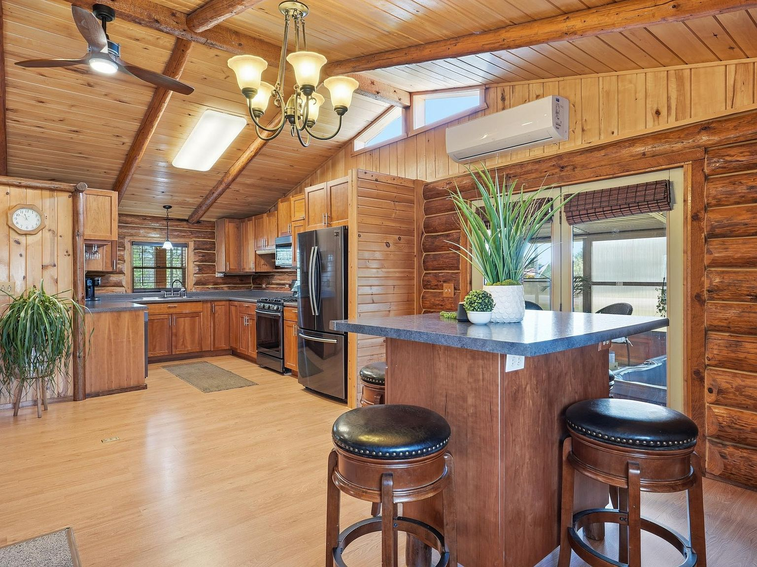 Kitchen with vaulted wood ceilings and black stainless steel appliances
