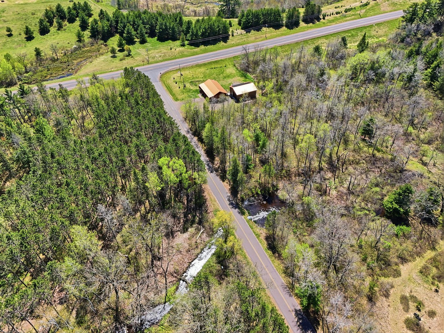 Aerial of property showing Potato Creek stream at the edge of the forest