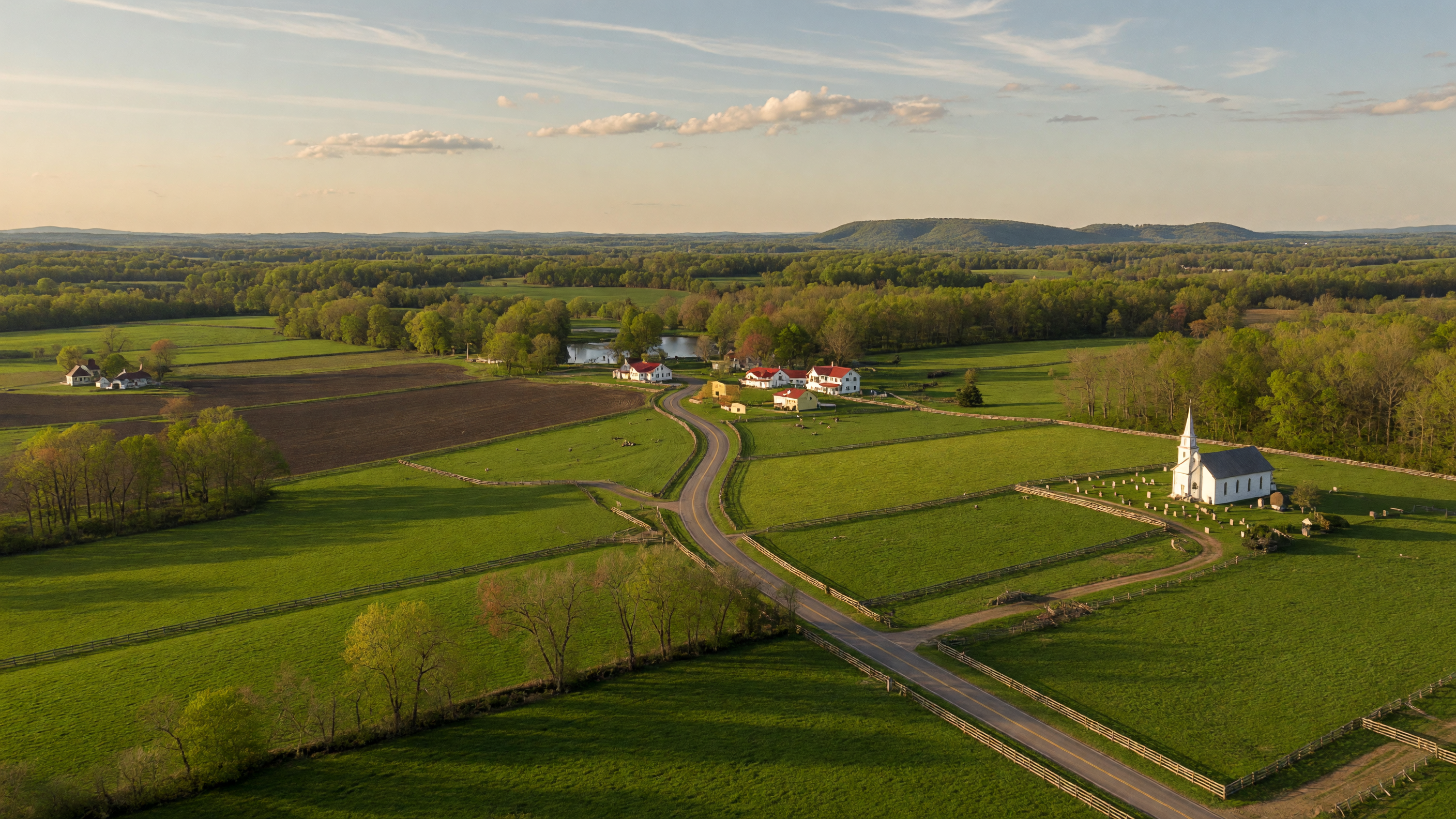 Rolling green farmland and tree-lined country roads in New Kent County, Virginia