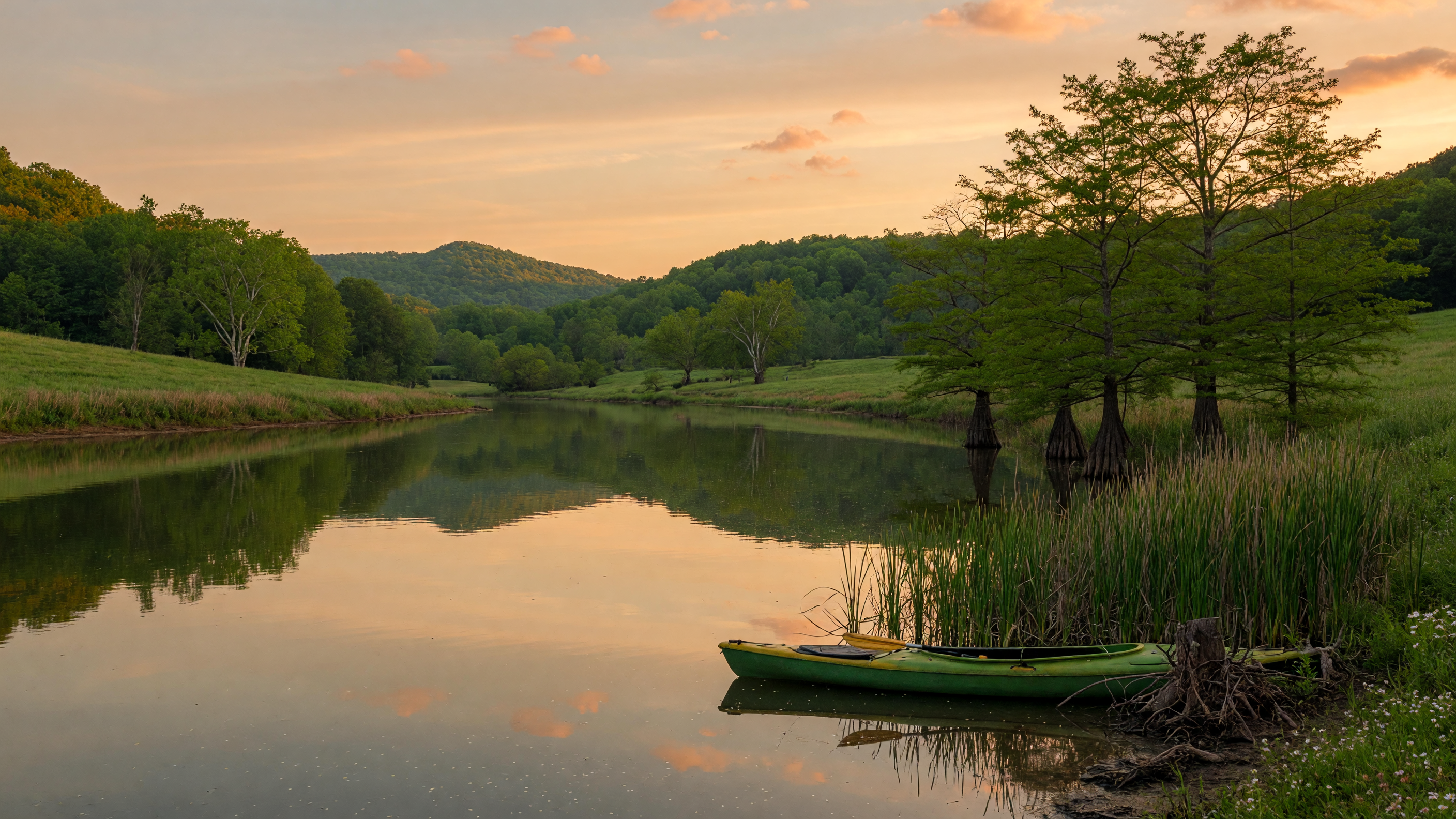 Calm Virginia river at golden hour with reflections of green trees on glassy water and a small fishing kayak near the shore