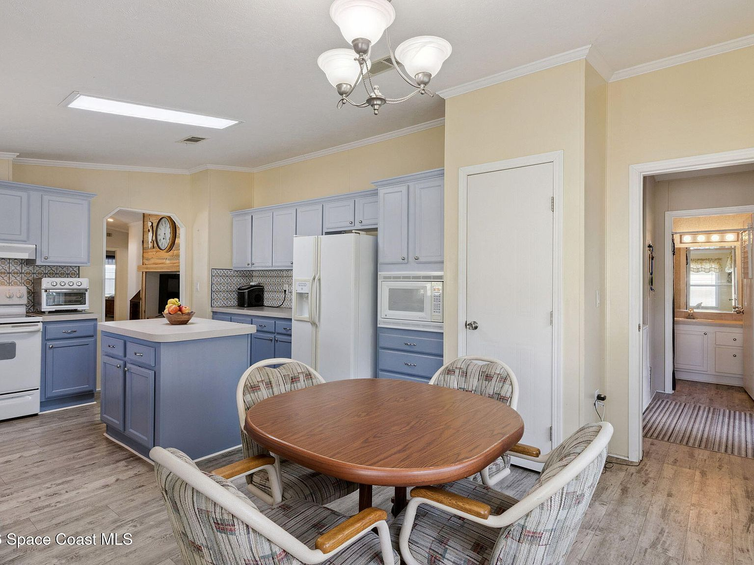 Kitchen and dining space with light blue cabinetry