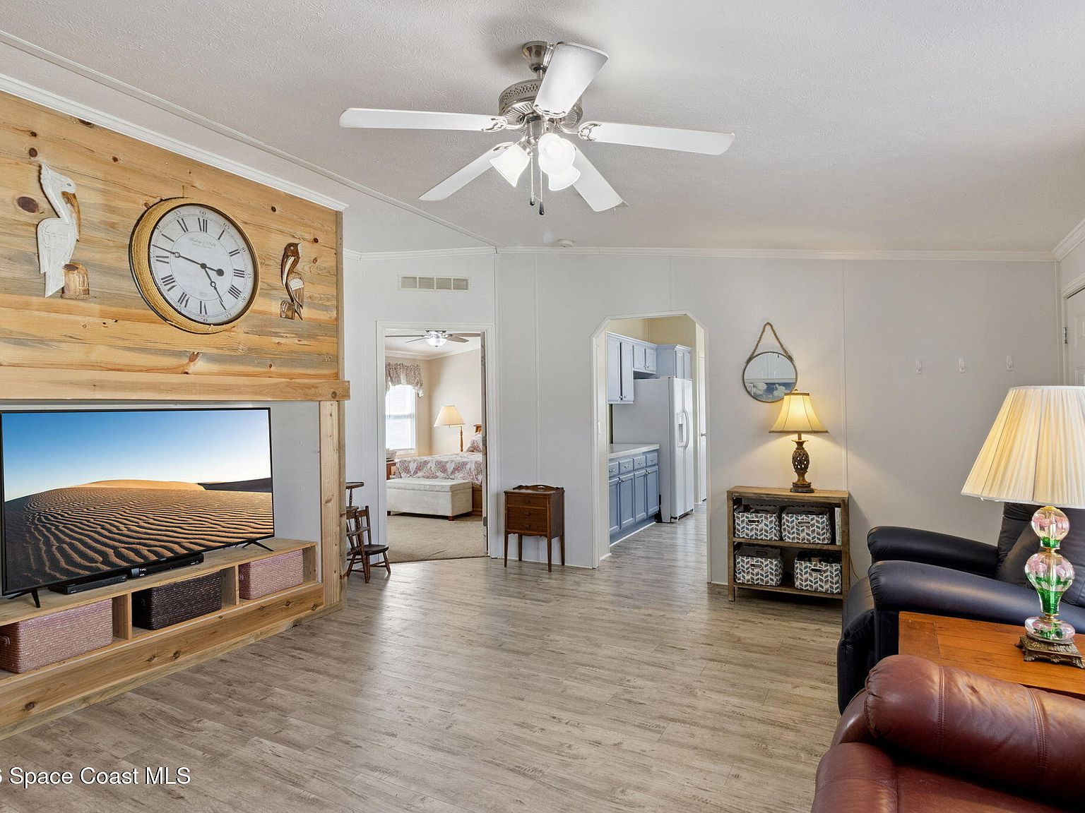 Living room with laminate flooring and wood-plank accent wall