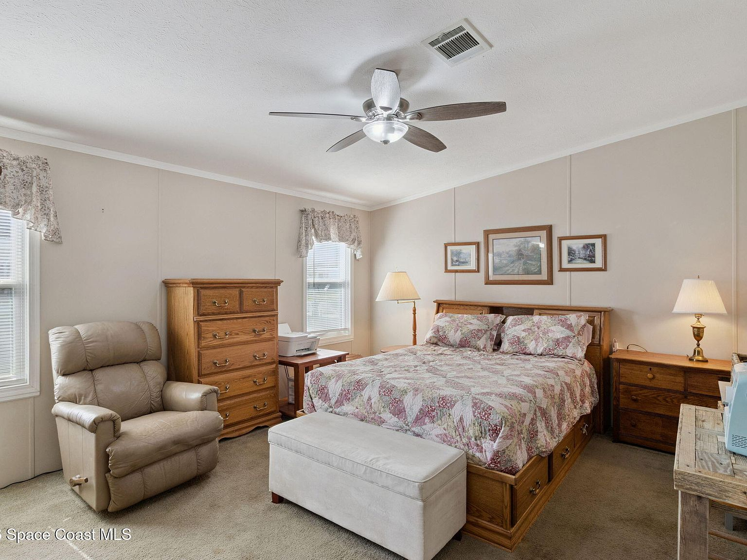 Primary bedroom with carpet flooring and natural window light