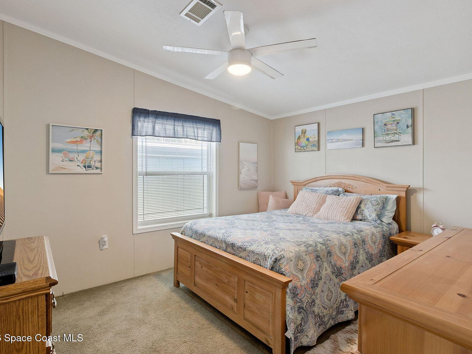 Master bedroom with wooden bed frame and furniture