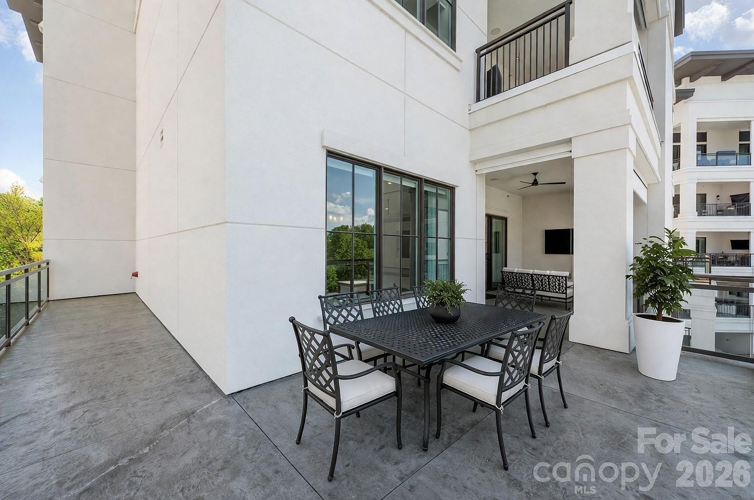 Condo balcony with outdoor dining and lounge furniture