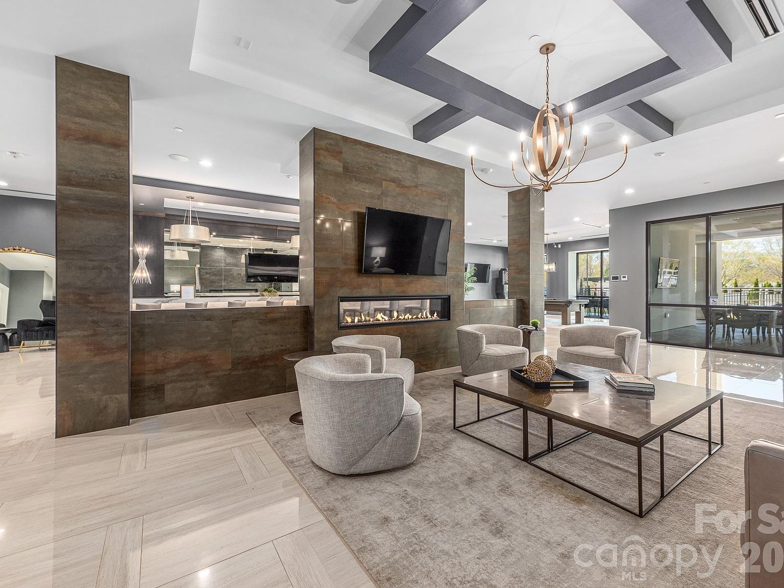 Living room with tiled fireplace feature wall and sculptural chandelier
