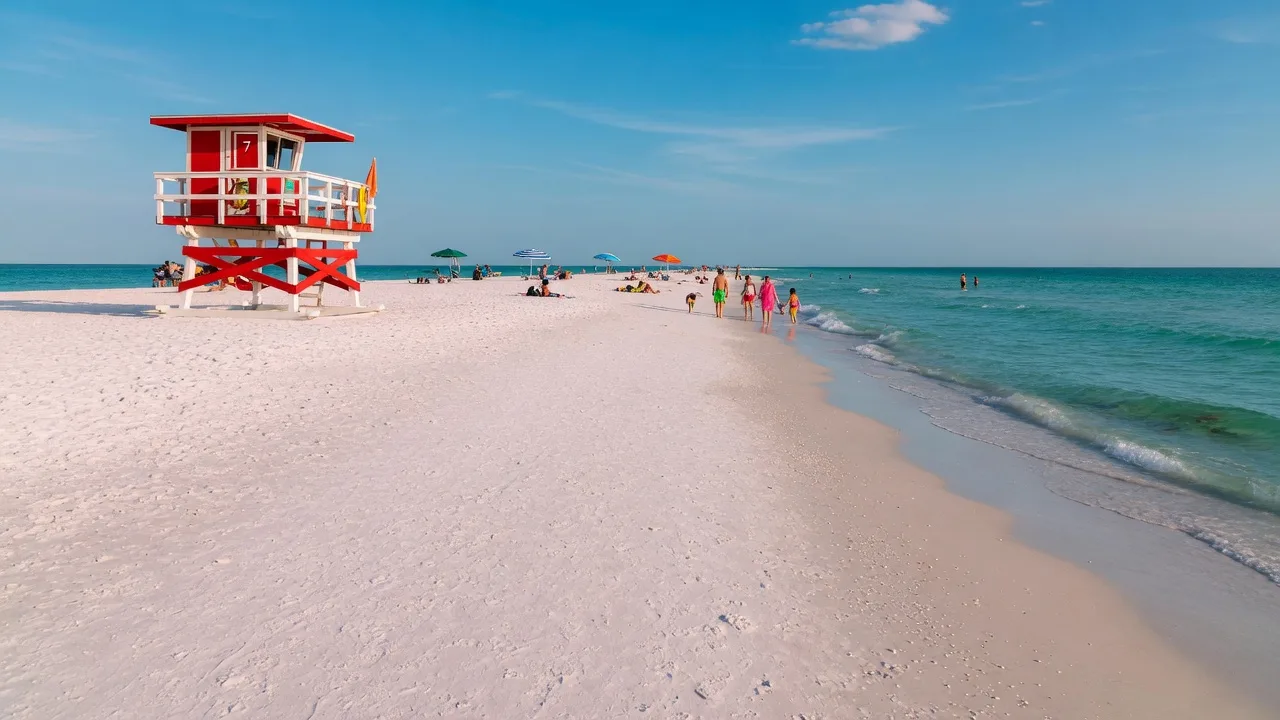 Siesta Key's white quartz sand beach with lifeguard tower and turquoise Gulf water