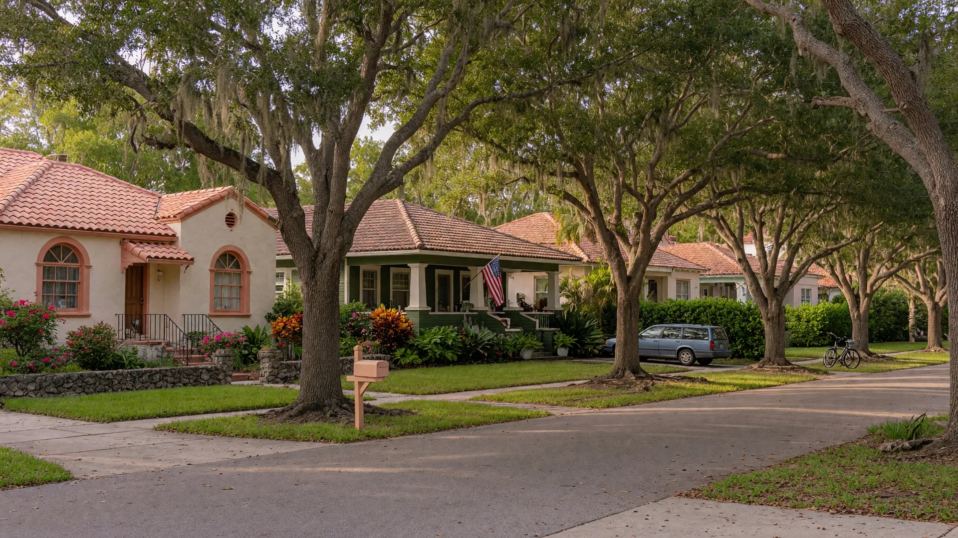 Tree-lined residential street in West of Trail, Sarasota — historic homes with mature oak canopy