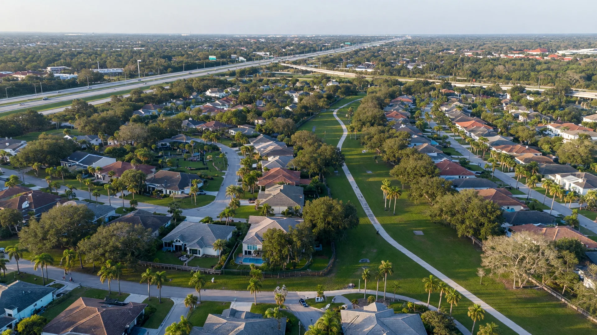 Aerial view of Palmer Ranch in south Sarasota Florida — master-planned community with mature tree canopy, parks, and Legacy Trail