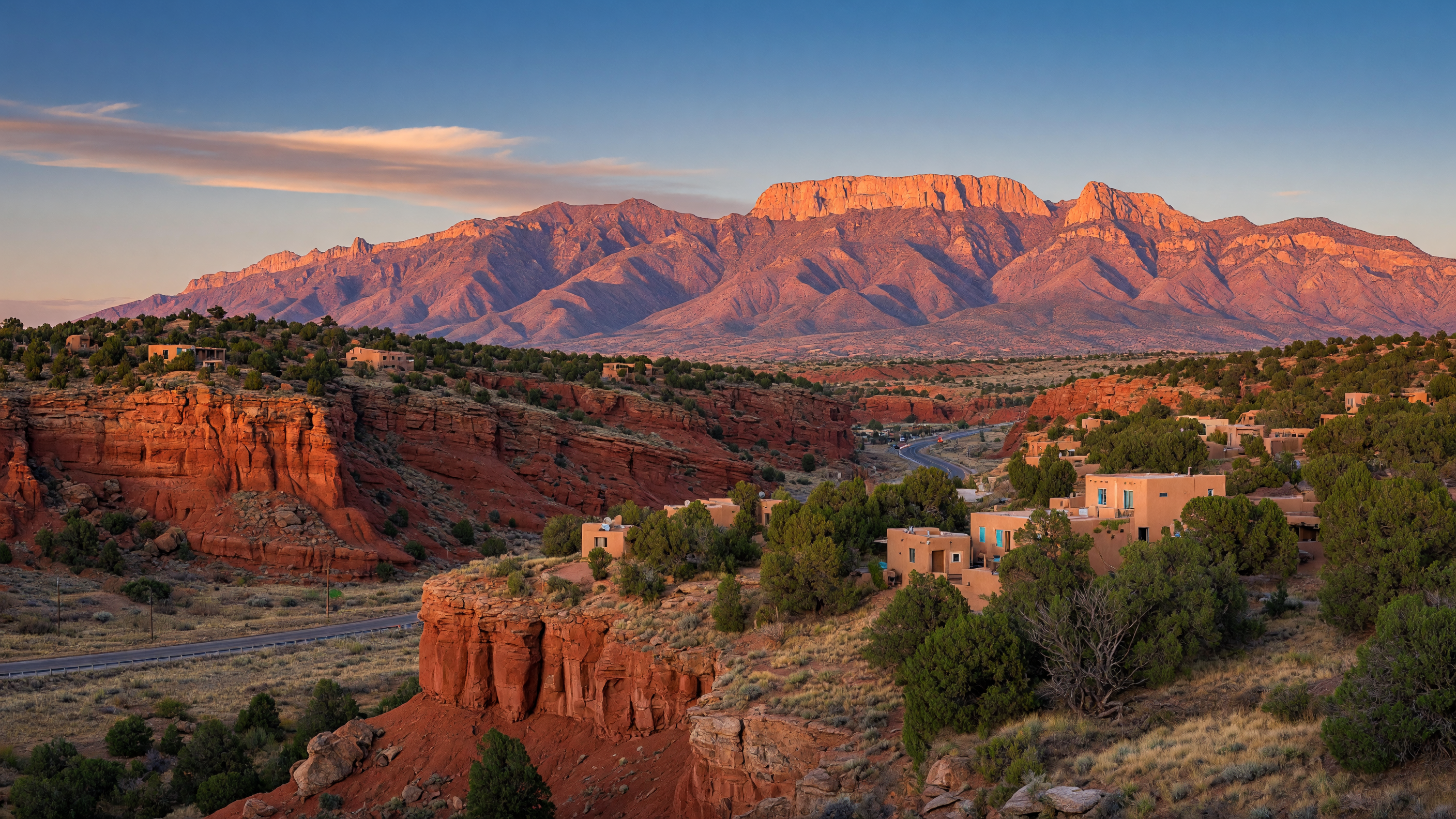 Panoramic view of Placitas and Bernalillo, New Mexico with sandstone cliffs, desert homes, and Sandia Mountains at golden hour